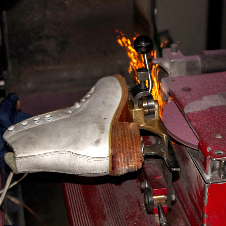 Figure skate getting hand sharpened